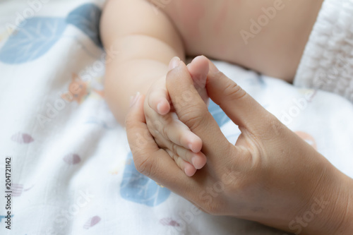 Baby hands in mother hands. Mom and her Child.Happy Family concept