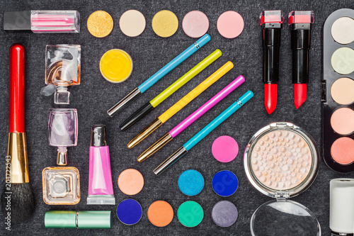 collection of various decorative cosmetics including lipstick, eye pencil powder mascara and perfumes. concept of professional make up artist tools