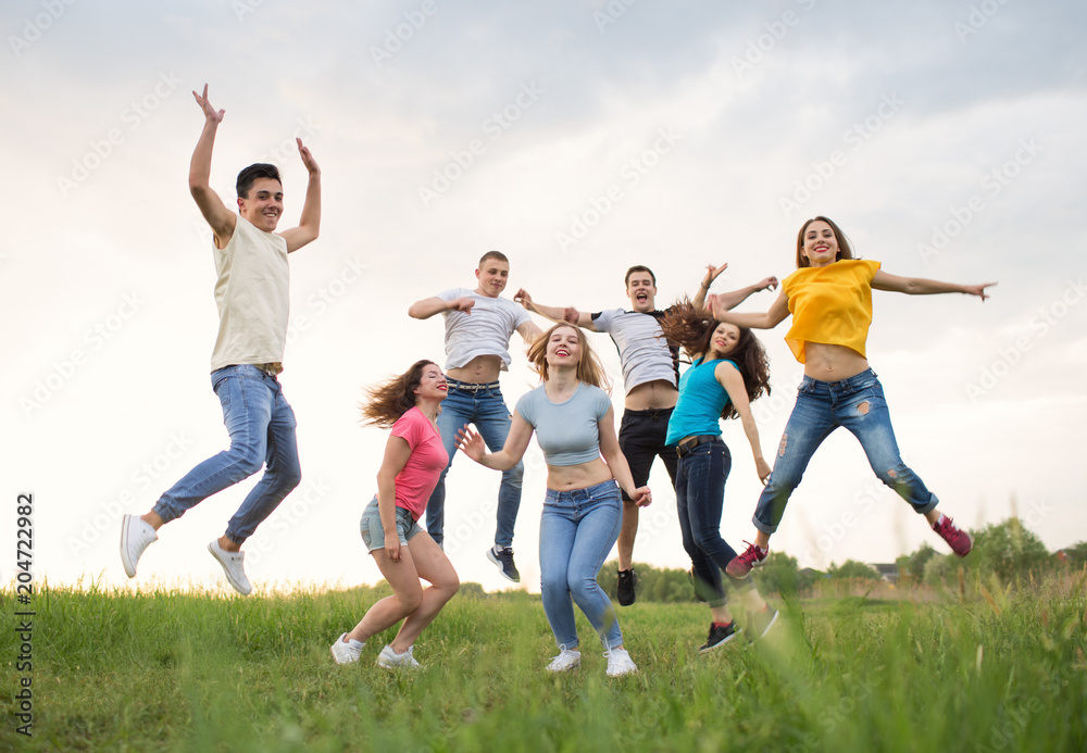 Young people jumping against the sunset sky Young people jumping against the sunset sky