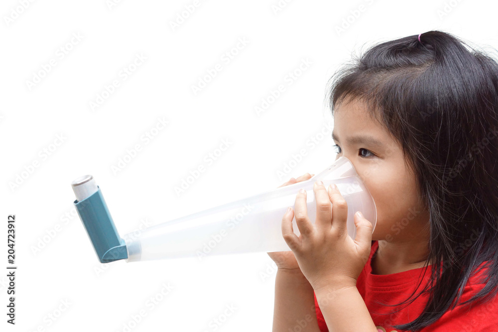 A girl using a treatment spray to deal with asthma and breathing problems isolated A girl using a treatment spray to deal with asthma and breathing problems isolated