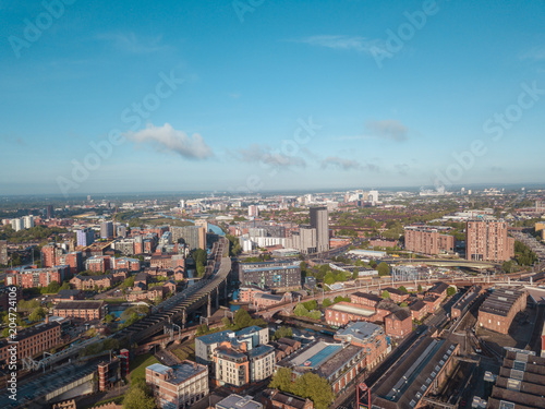 Fototapeta Naklejka Na Ścianę i Meble -  Manchester City Centre Drone Aerial View Above Building Work Skyline Construction Blue Sky Summer Beetham Tower Deansgate.