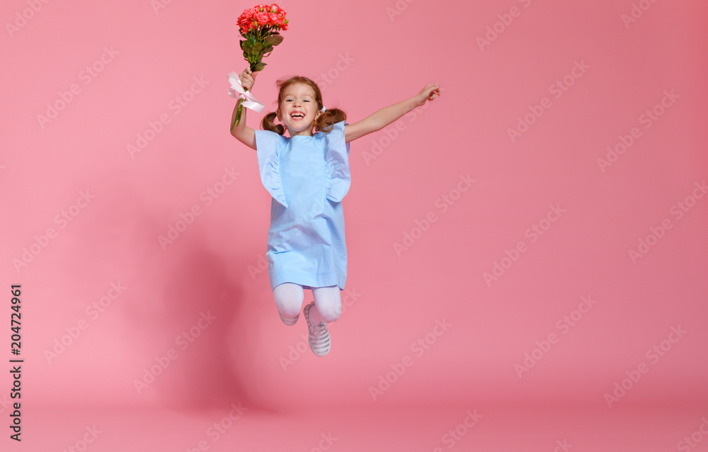 funny child girl runs and jumps with bouquet of flowers on colored background funny child girl runs and jumps with bouquet of flowers on colored background