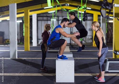 athletes working out jumping on fit box