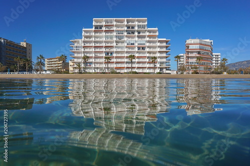 Beach with buildings seen from water surface, Spain, Costa Brava, Mediterranean sea, Santa Margarida, Roses, Catalonia, Girona © dam