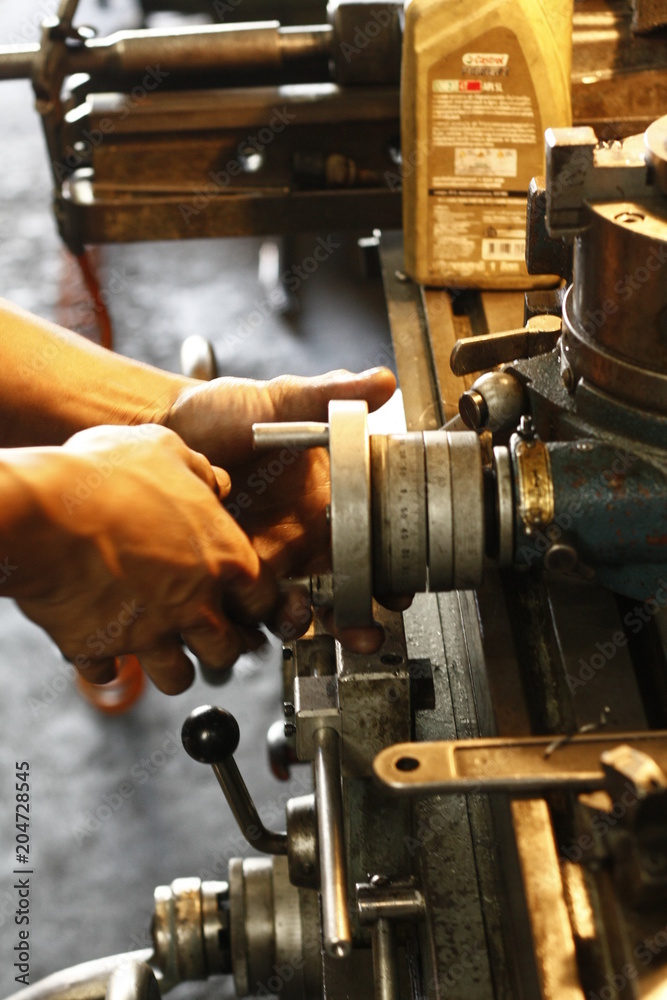Metal engine parts being drilled, bored and lathed in a metal engineering workshop in Thailand, Southeast Asia Metal engine parts being drilled, bored and lathed in a metal engineering workshop in Thailand, Southeast Asia