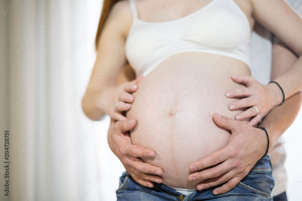 Husband and pregnant wife in a room Husband and pregnant wife in a room