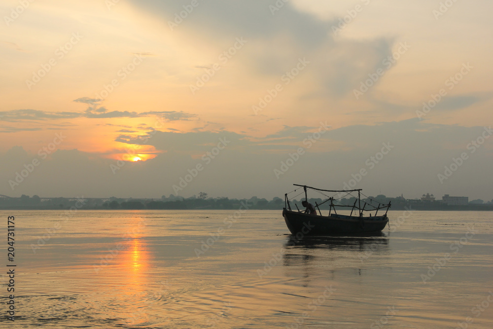 A boat at sunrise by Ganges river in Varanasi, India. Travel destination concept A boat at sunrise by Ganges river in Varanasi, India. Travel destination concept
