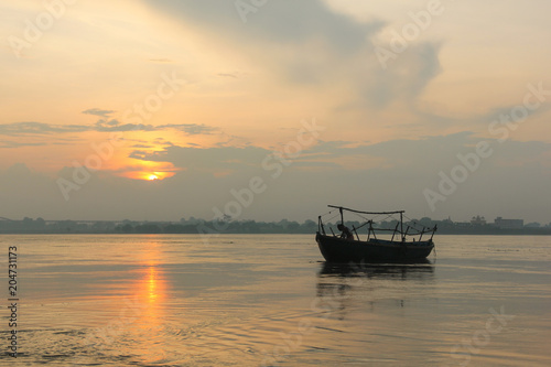 A boat at sunrise by Ganges river in Varanasi, India. Travel destination concept