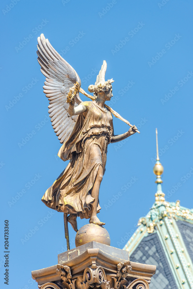 Obraz premium Statue of beautiful angel with wings in front of the Rudolfinum concert hall in Prague, Czech Republic