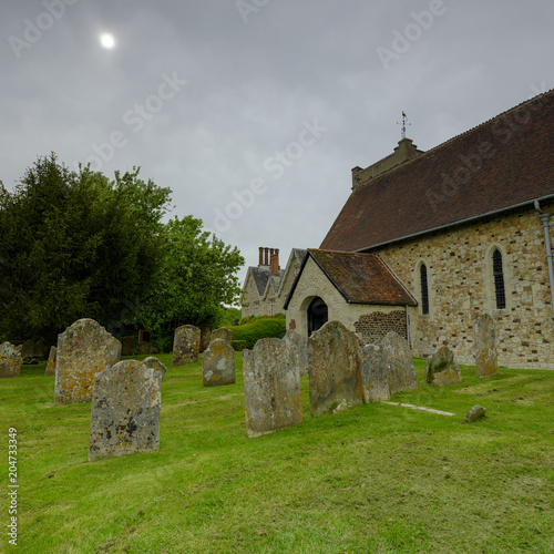 Spring afternoon light on an overcast day - View of St Mary's Church in Selborne, Hampshire, UK photo
