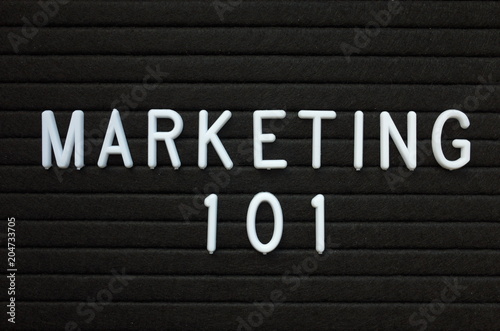 The words Marketing 101 in white plastic letters on a black letter board as an introduction to the methods used to promote your business or idea