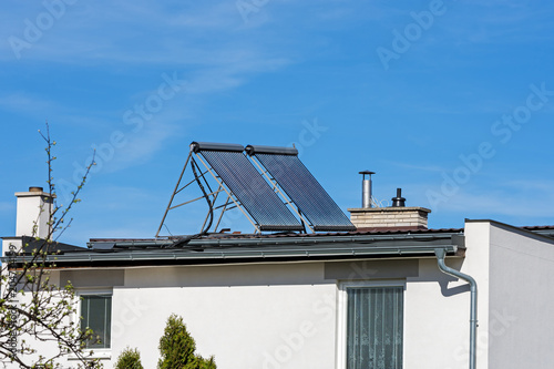 green energy, solar collectors on the roof of a family house