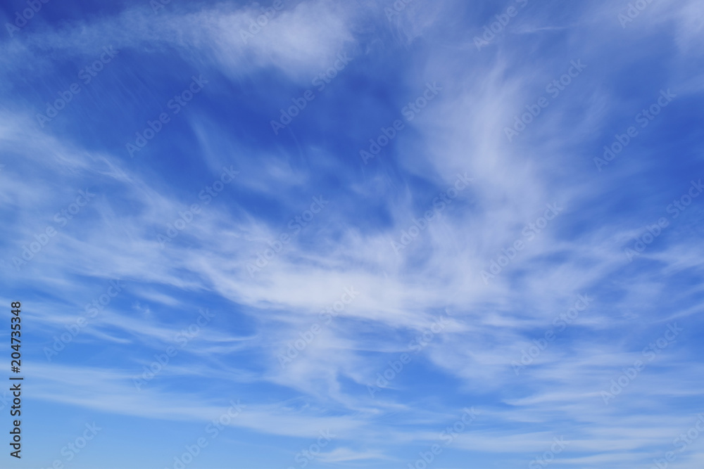 beautiful blue sky, airy white clouds, free space for text