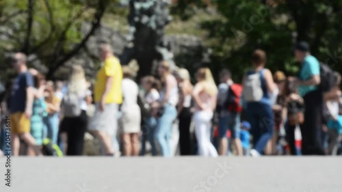 Wallpaper Mural Anonymous blurred crowd of people standing near a sculpture on a sunny day Torontodigital.ca