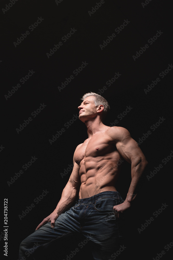 Muscular and sexy torso of young man having perfect abs, bicep and chest. Male hunk with athletic body. Fitness concept