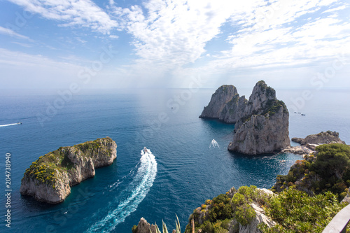 Fototapeta Naklejka Na Ścianę i Meble -  Capri Italy, island in a beautiful summer day, with faraglioni rocks and natural stone arch.