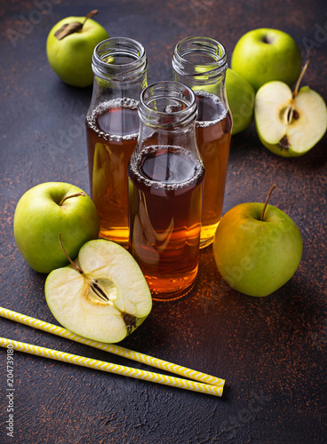 Bottles with fresh apple juice 