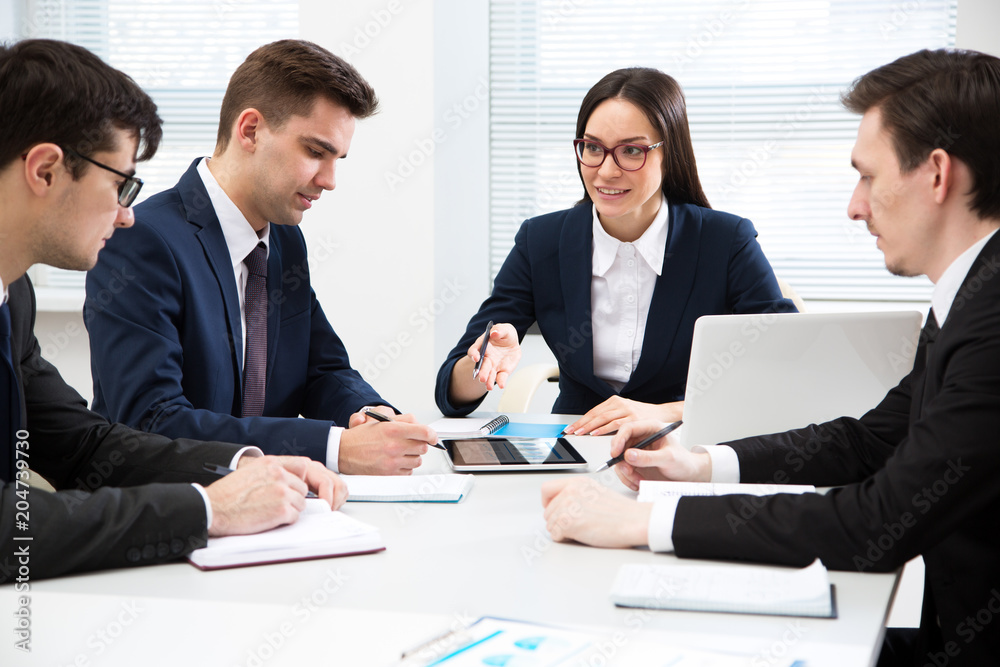 Businesswoman explains to businessmen a new project Businesswoman explains to businessmen a new project