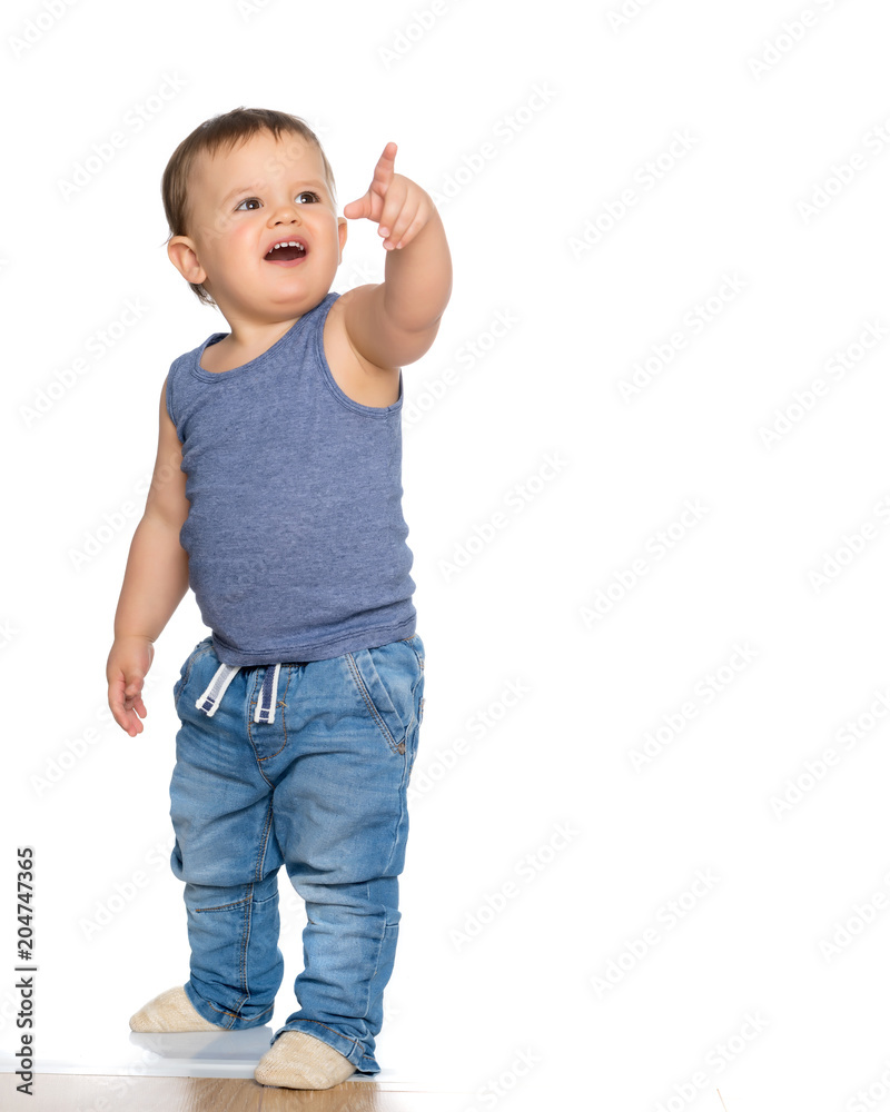 The boy points a finger at something.