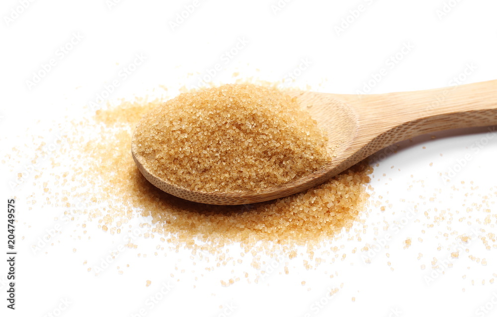 Brown sugar cane and wooden spoon isolated on white Brown sugar cane and wooden spoon isolated on white