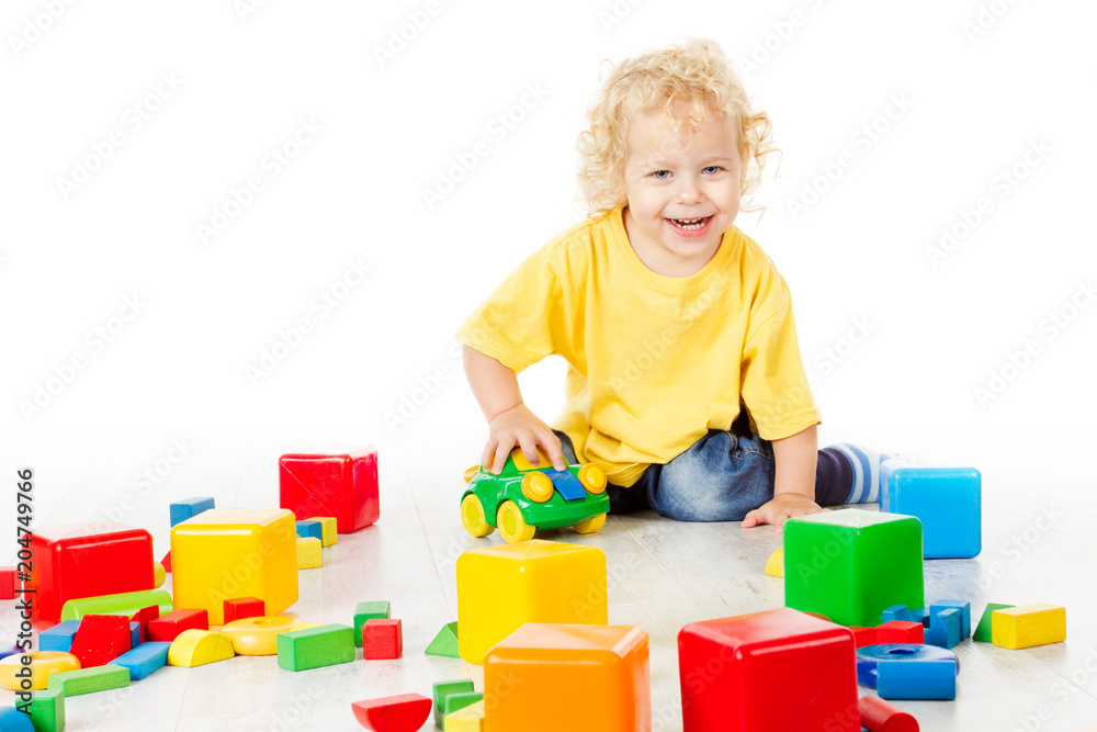 Child Play Blocks Toys, Kid Sitting on Floor and Playing Colorful Building Bricks, Baby Boy Isolated over White Background Child Play Blocks Toys, Kid Sitting on Floor and Playing Colorful Building Bricks, Baby Boy Isolated over White Background