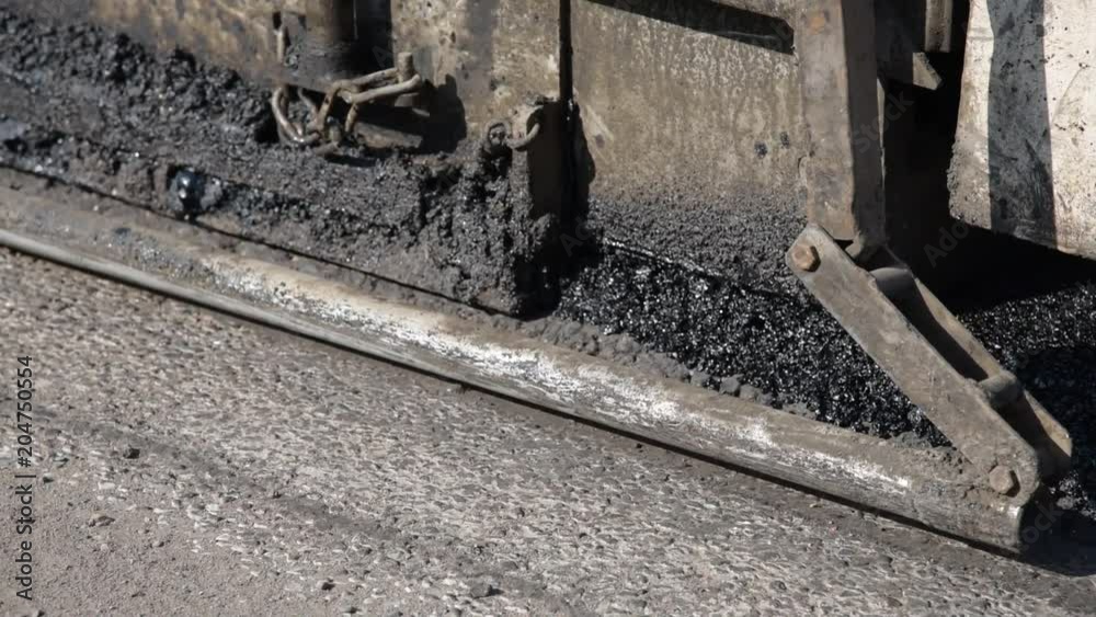 Application of asphalt on the road with an automatic machine Application of asphalt on the road with an automatic machine
