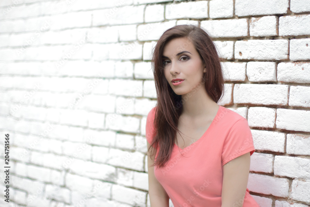 Beautiful modern girl near the white brickwall. Youth street style. place for text Beautiful modern girl near the white brickwall. Youth street style. place for text