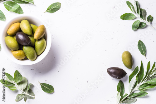 Black and green Olives on white background.