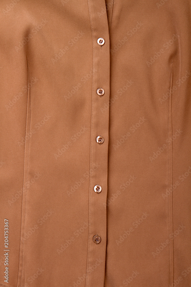 Female brown buttoned shirt background. Detail of women classic blouse. Feminine formal apparel.