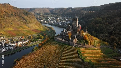 Flight over autumn Cochem castle, Mosel valley, Germany photo