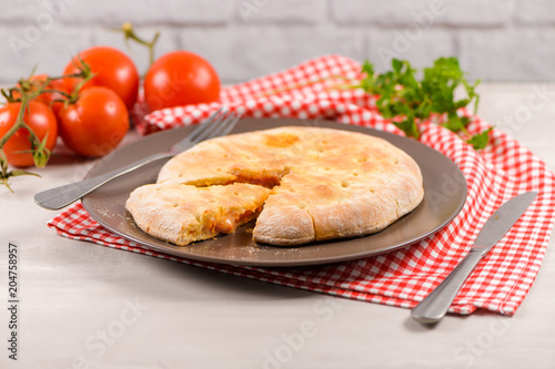 Pizza calzone on wooden background