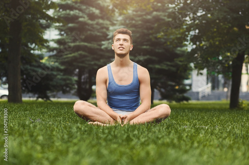 Young man practicing yoga, relax meditation pose