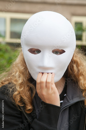 Girl with white mask. He is afraid of something.