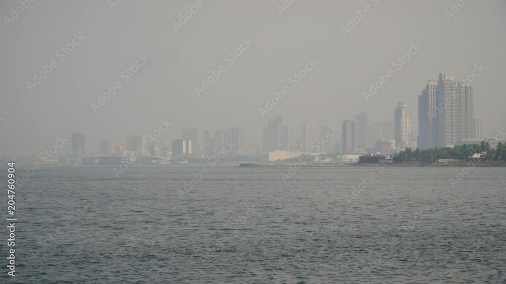 Panorama Manila city, skyscrapers and buildings. Seascape coastal city of Manila. Modern city by sea. Makati district. Travel concept. Panorama Manila city, skyscrapers and buildings. Seascape coastal city of Manila. Modern city by sea. Makati district. Travel concept.