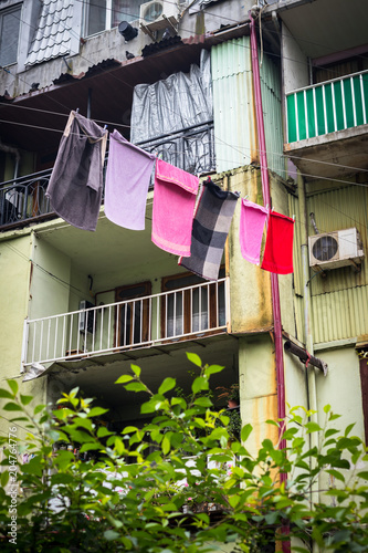 Batumi, Georgia - May 12 2018: Colorful drying clothes in Georgia hanging from balconies. Traditional Georgian method of drying clothes.
