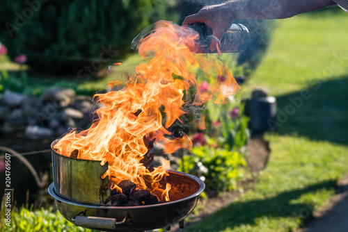 Liquid grill lighter on a charcoal grill