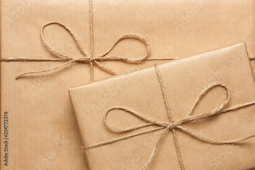 Close up of two gift boxes wrapped in brown recycled paper