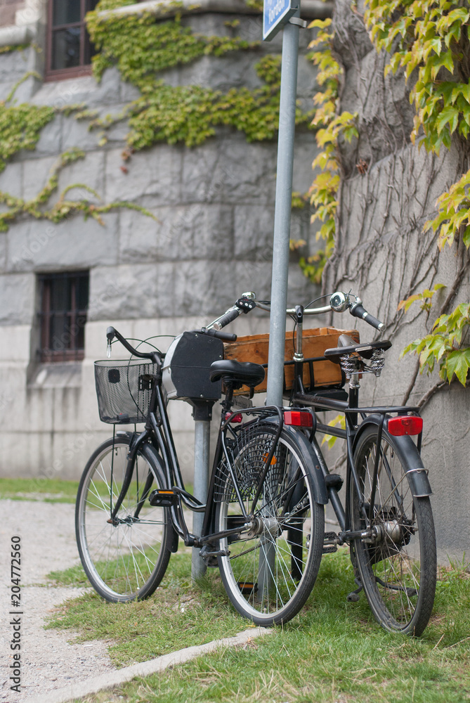 Two bicycles near a wal