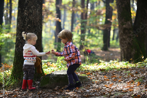 Childhood and child friendship, love and trust. Little boy and girl friends camping in woods. Kids activity and active rest. Brother and sister have fun on fresh air. Children play in autumn forest