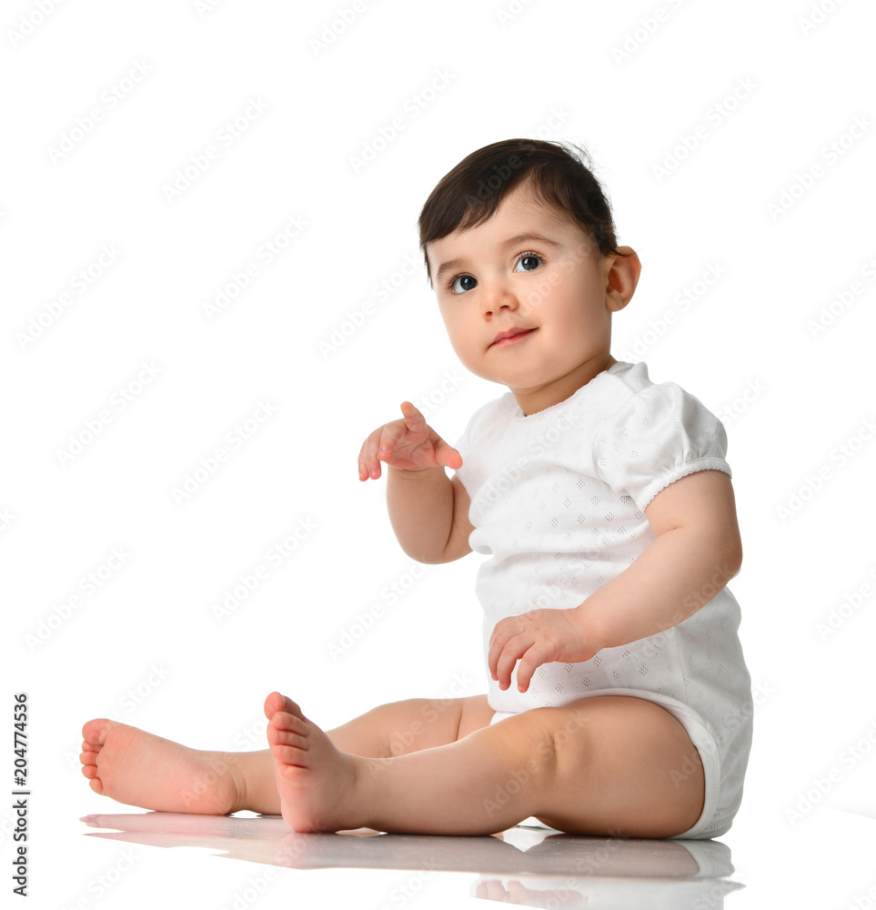 9 month infant child baby girl toddler sitting in white shirt pointing finger isolated on a white 9 month infant child baby girl toddler sitting in white shirt pointing finger isolated on a white