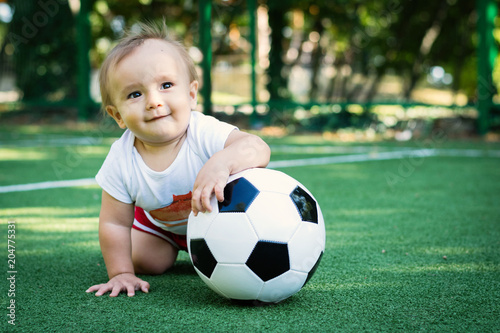 Dreaming little boy at the stadium with a soccer ball. Future football star © AMR Studio