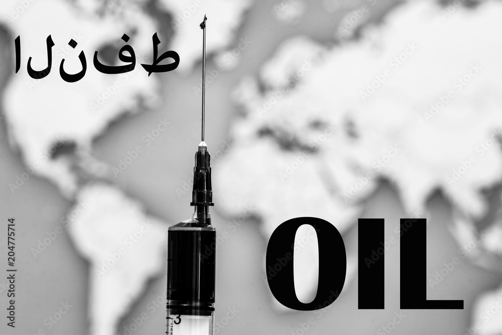 Needle syringe. Inside the syringe is oil. In the background is a map