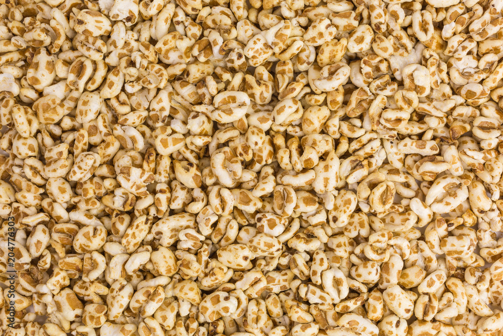 background of puffed spelt cereal with honey