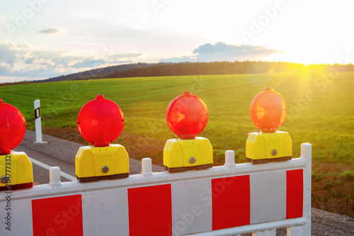 closeup of street warning lights at road on countryside