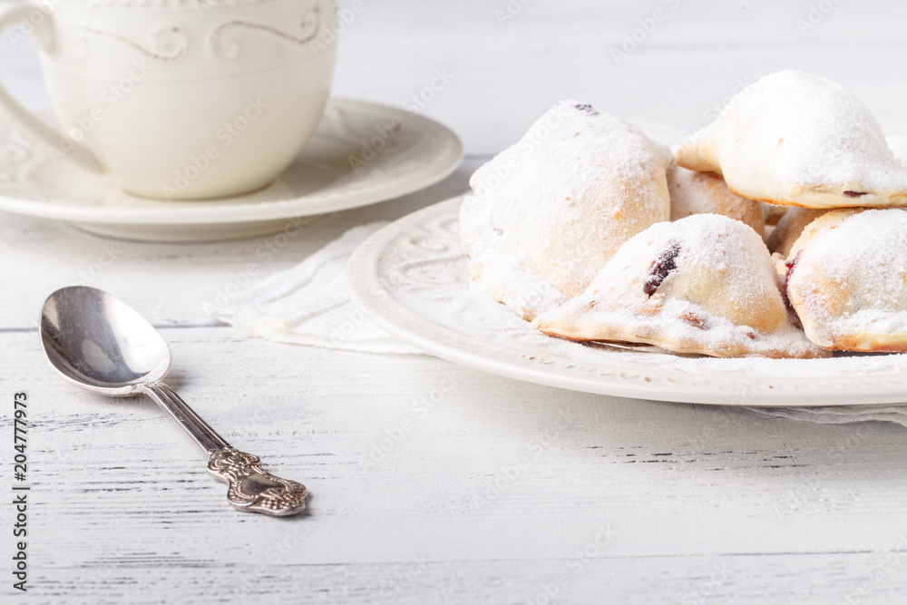Homemade savory hand pies with cup of tea, breakfast concept Homemade savory hand pies with cup of tea, breakfast concept