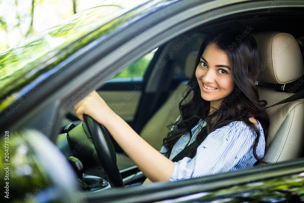 Pretty young woman driving her new car. Pretty young woman driving her new car.