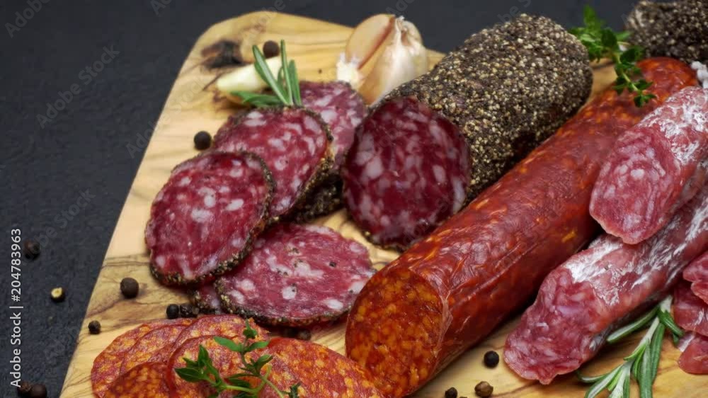 salami and chorizo sausage close up on dark concrete background salami and chorizo sausage close up on dark concrete background