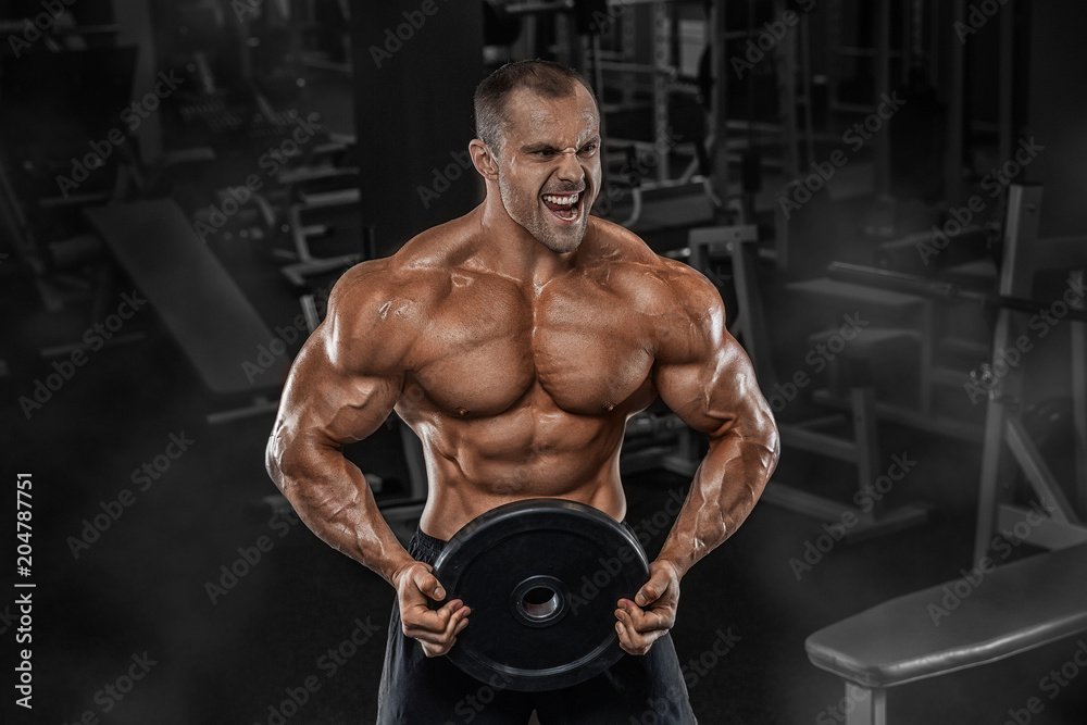 Closeup portrait of professional bodybuilder workout with barbell on black background. Muscular man training squats with barbells over head