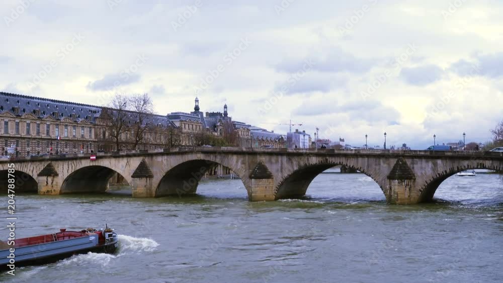 barge floating by the Seine river under the bridge at Paris barge floating by the Seine river under the bridge at Paris