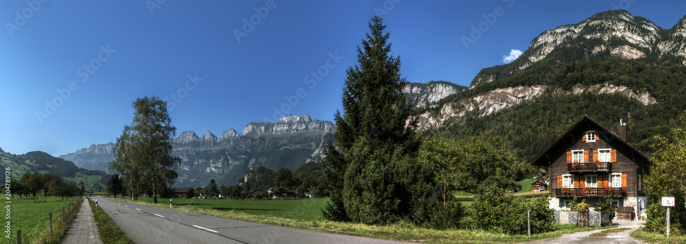 Road to Flums showing Swiss cottage and Churfirsten